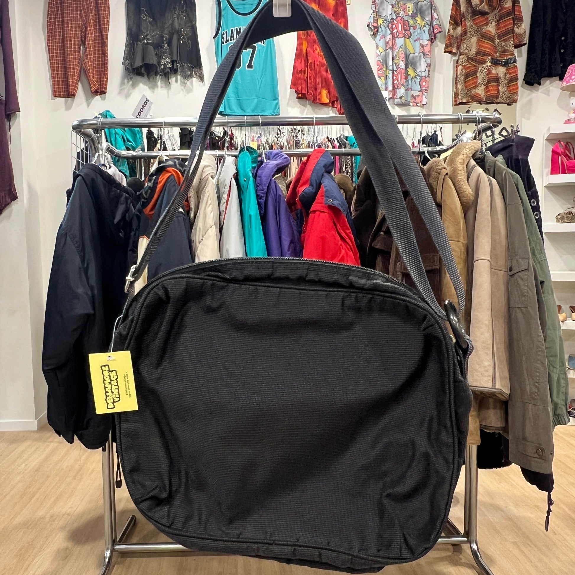 Black bag with a yellow tag in a clothing store