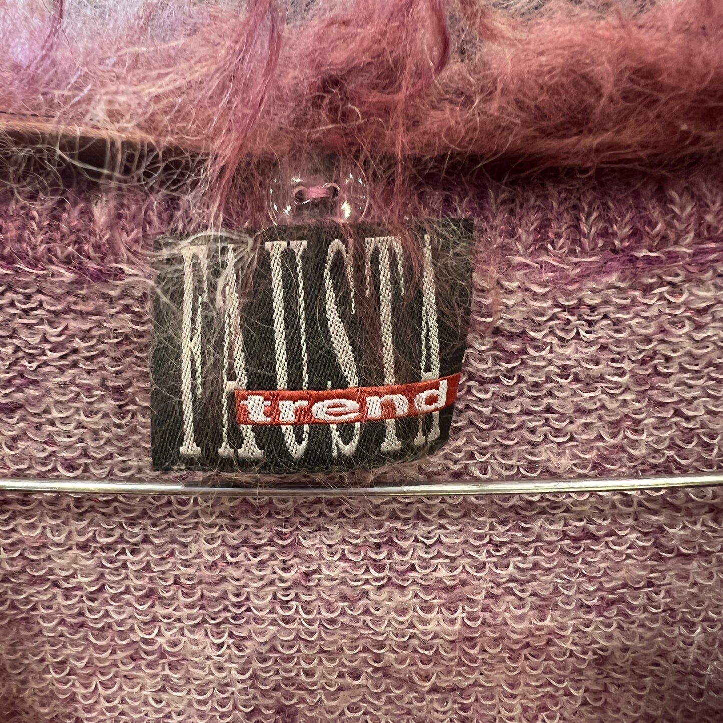 Close-up of a label on a textured fabric with 'trend' branding