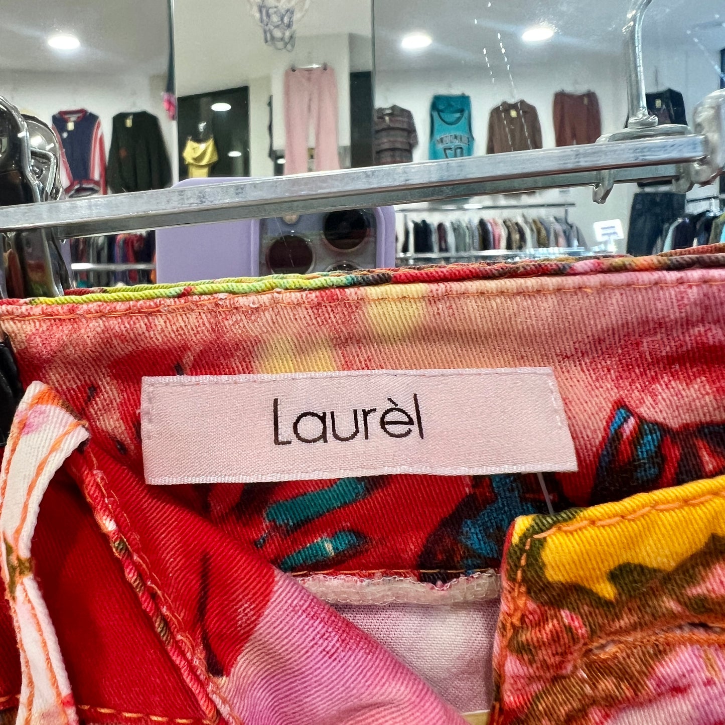 Colorful fabric with 'Laurel' label on a clothing rack