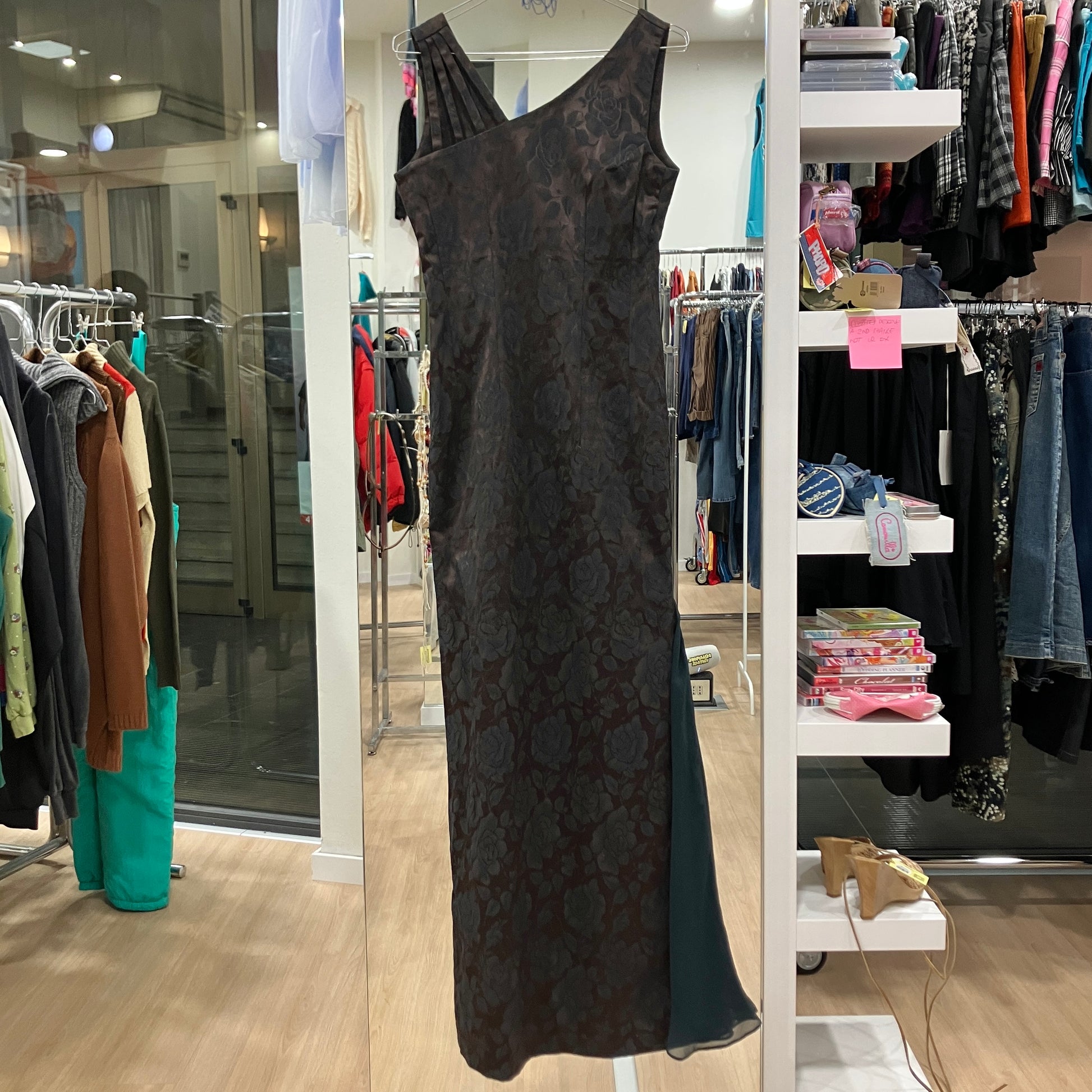 Black floral-patterned dress on a rack in a clothing store