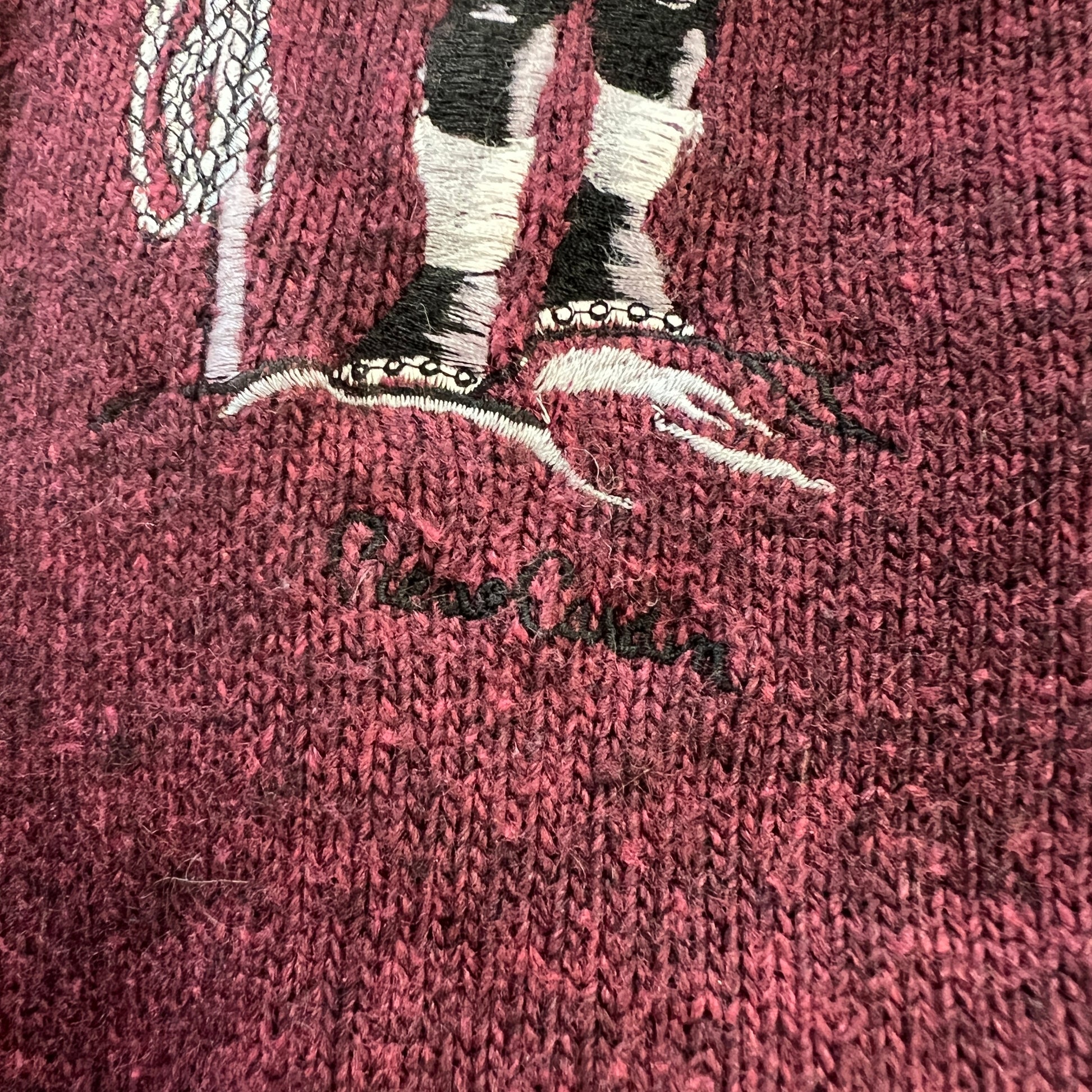 Embroidered design of a mermaid on a pink textured fabric