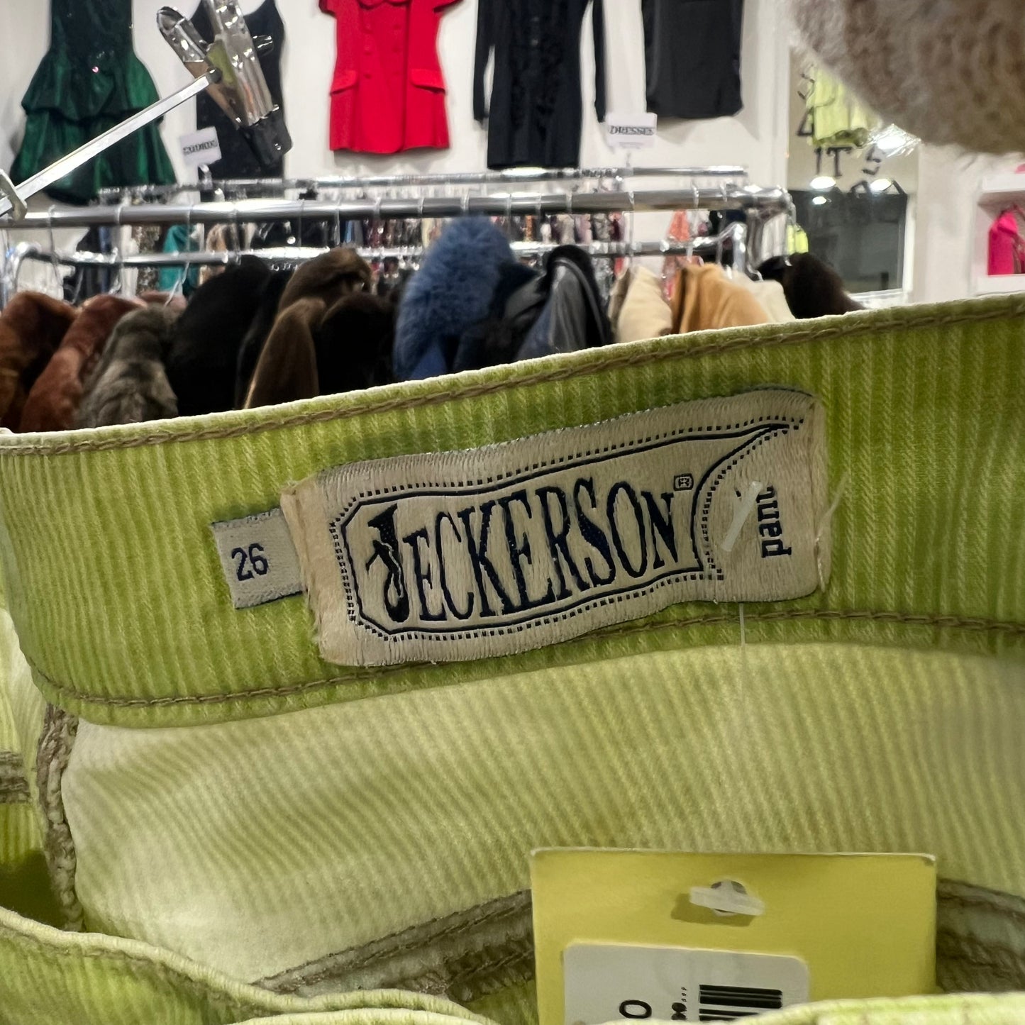 Green jacket with a 'Beckerson' label in a store setting