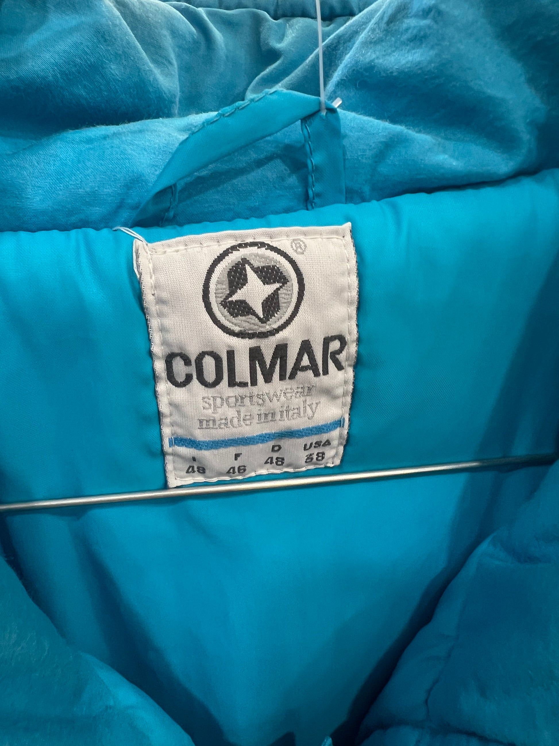 Close-up of a blue jacket with a Colmar label