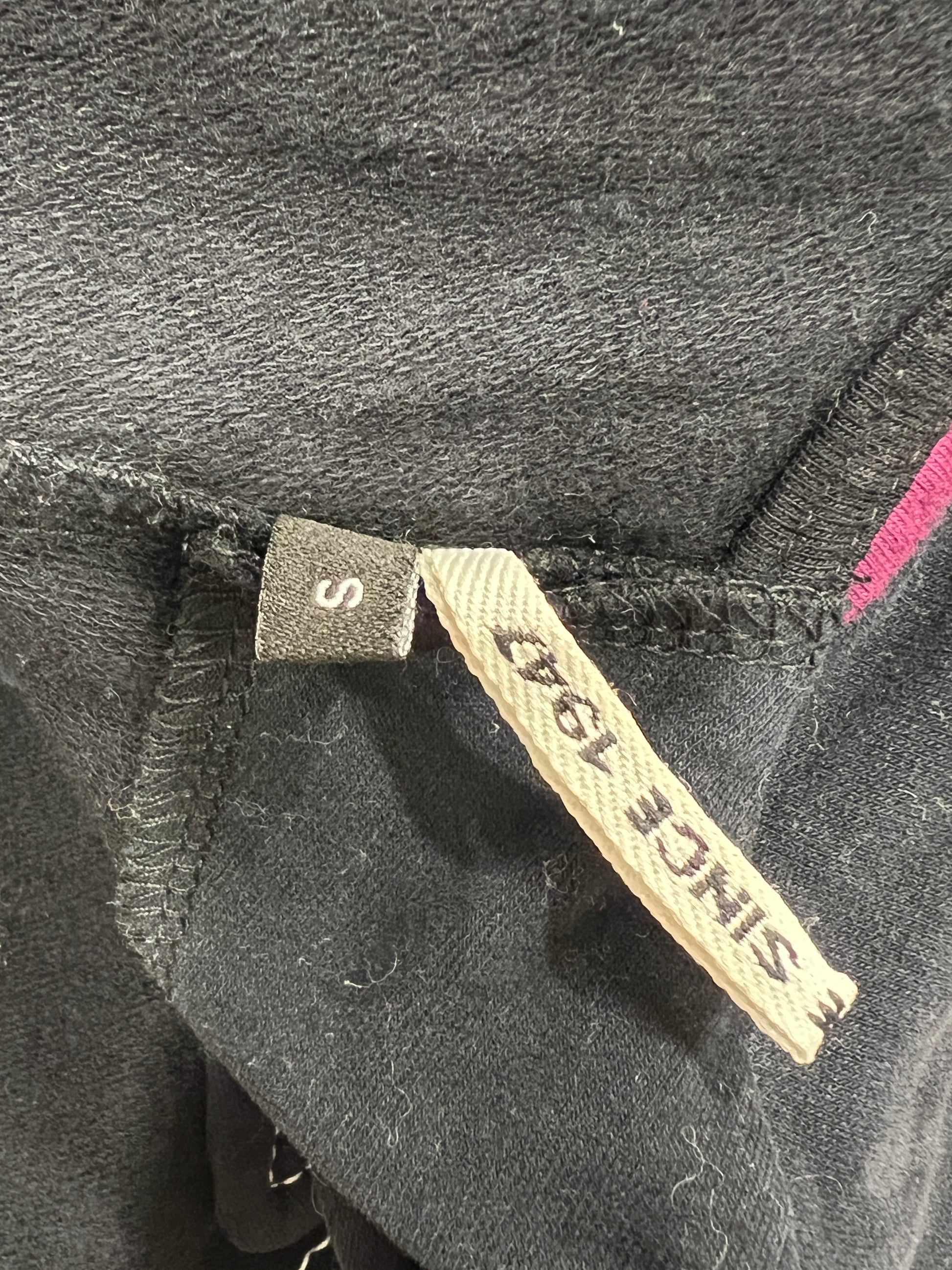 Close-up of a label on a dark fabric with 'since 1947' label