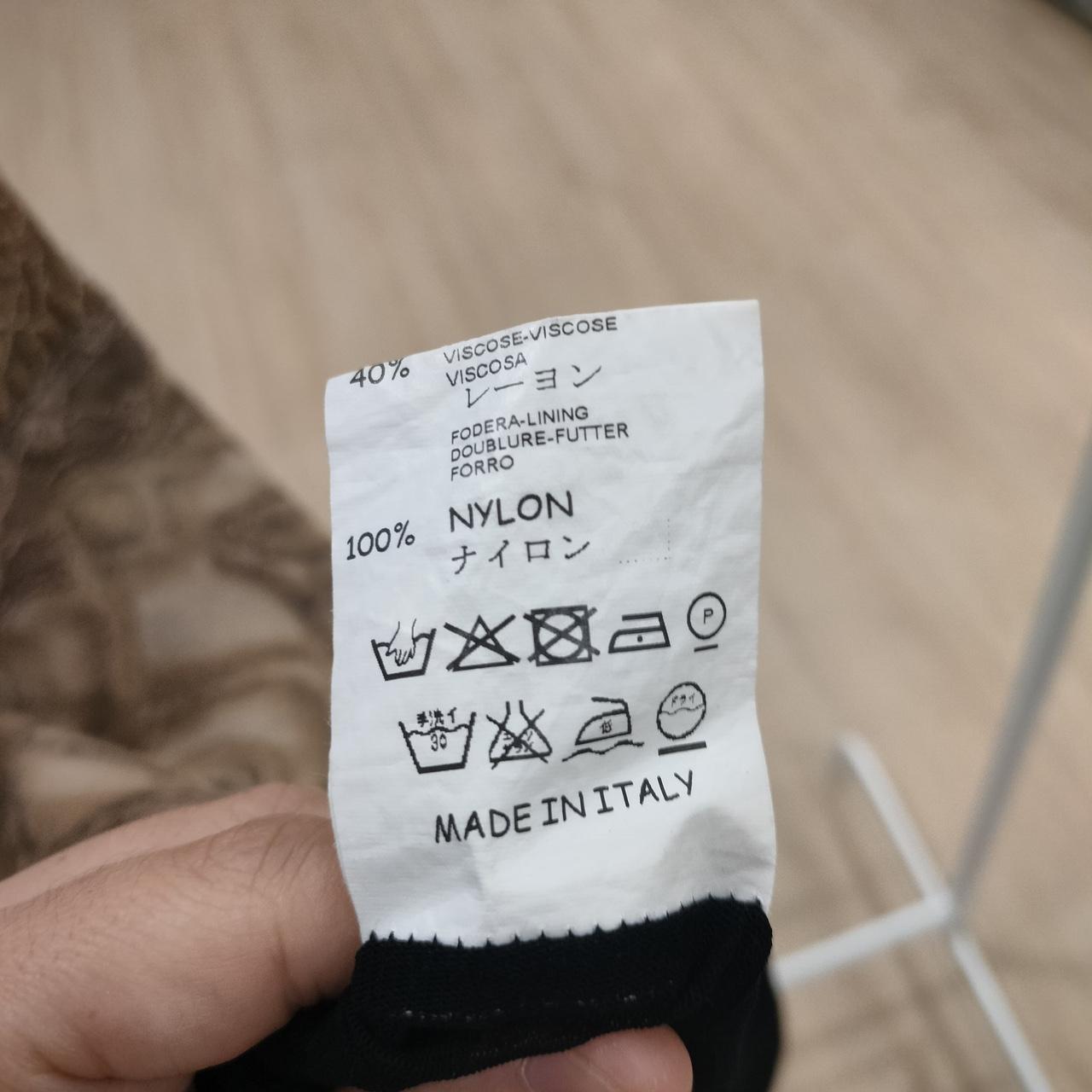 Clothing label with text and symbols on a blurred background