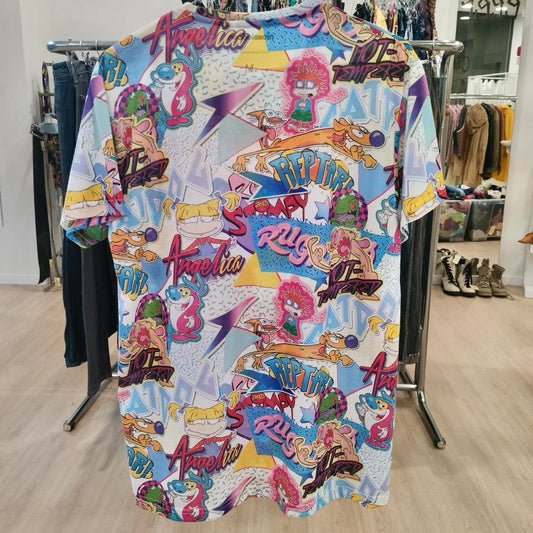 Colorful graphic t-shirt with various designs and text on a rack in a store