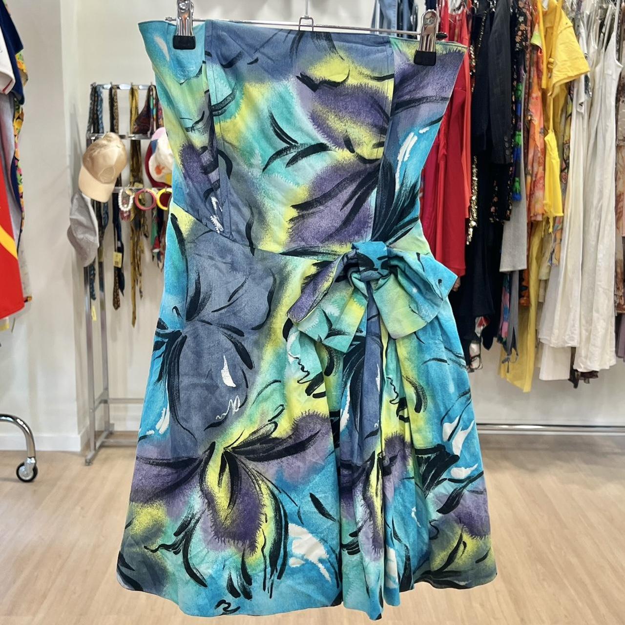 Colorful floral dress hanging on a rack in a store