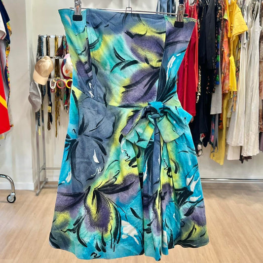 Colorful floral dress hanging on a rack in a store