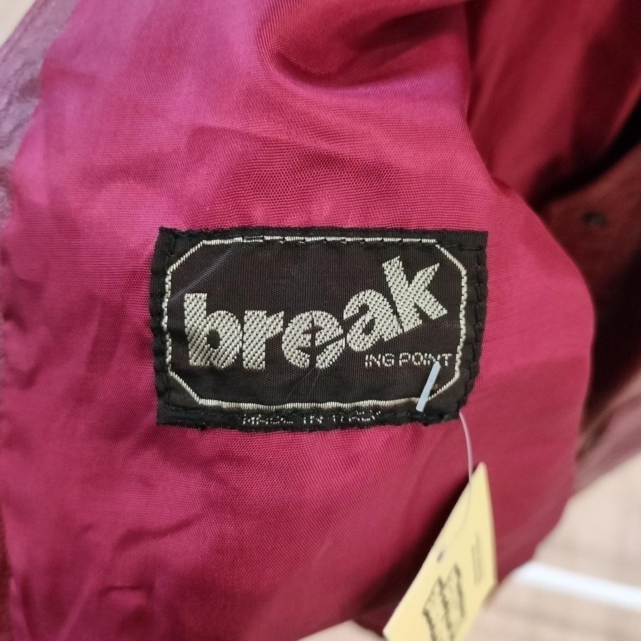 Close-up of a 'break' label on a red fabric background