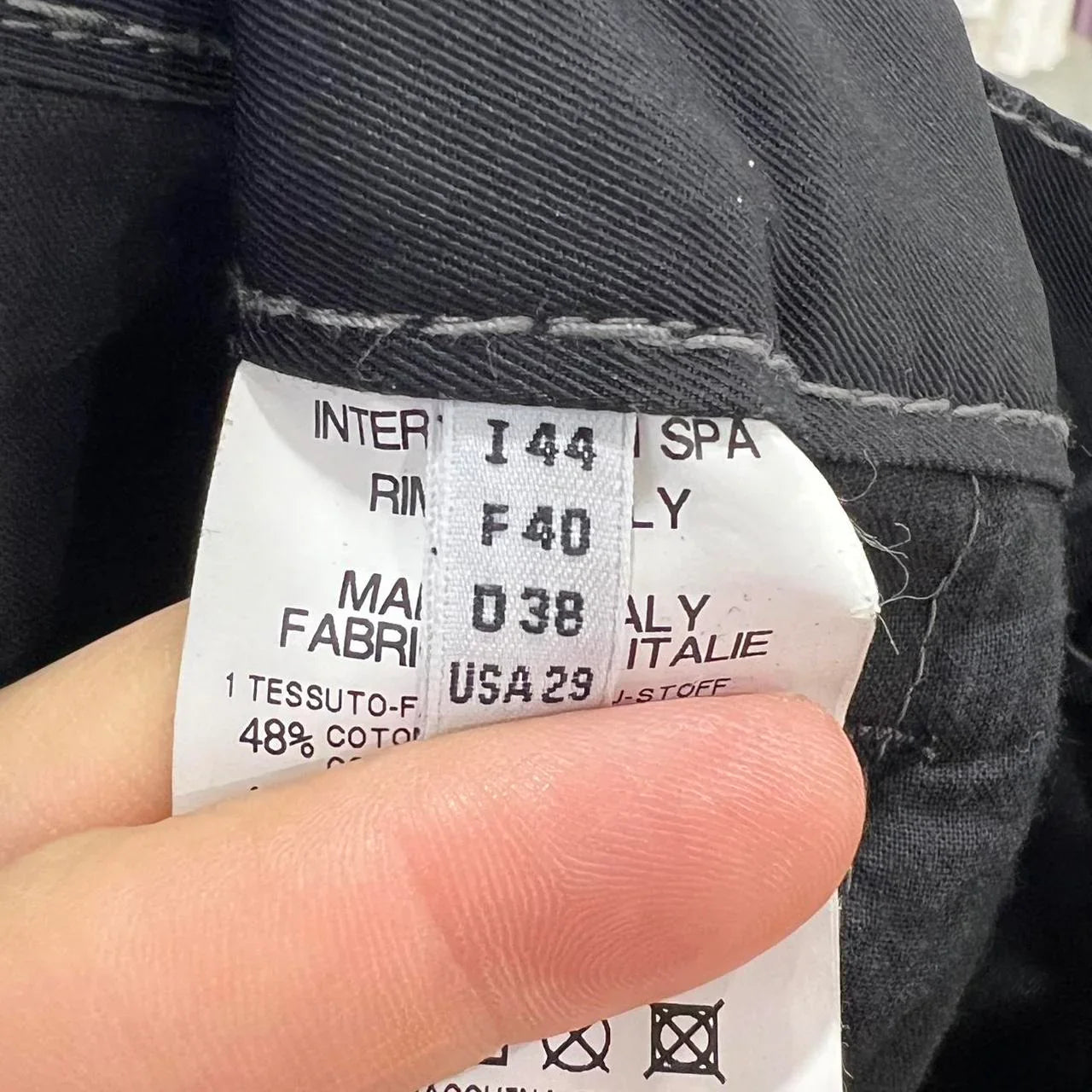 Close-up of a clothing label showing international size information and fabric content