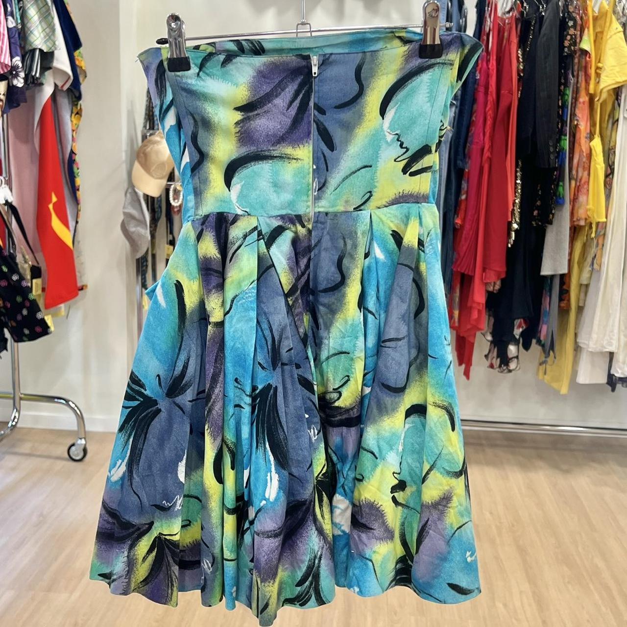 Colorful dress with abstract pattern on a rack in a store