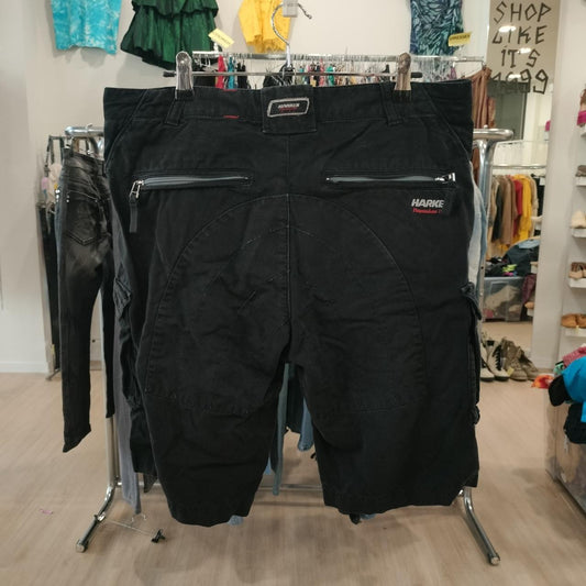 Black vintage HARKE shorts with zippered pockets, displayed in a second hand fashion store