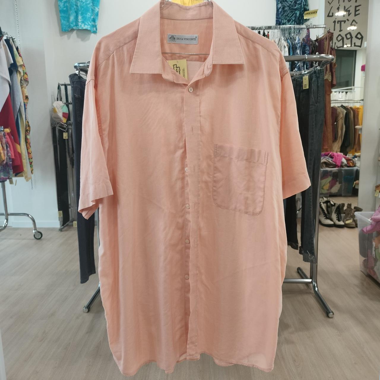 Pink shirt on a hanger in a store setting