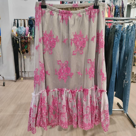 Floral skirt with pink and gray pattern hanging on a rack in a store