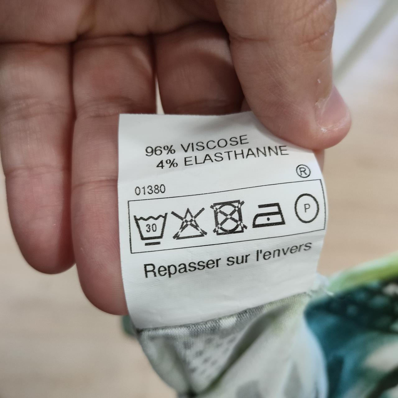 Clothing care label showing 96% viscose, 4% elastane, and washing instructions