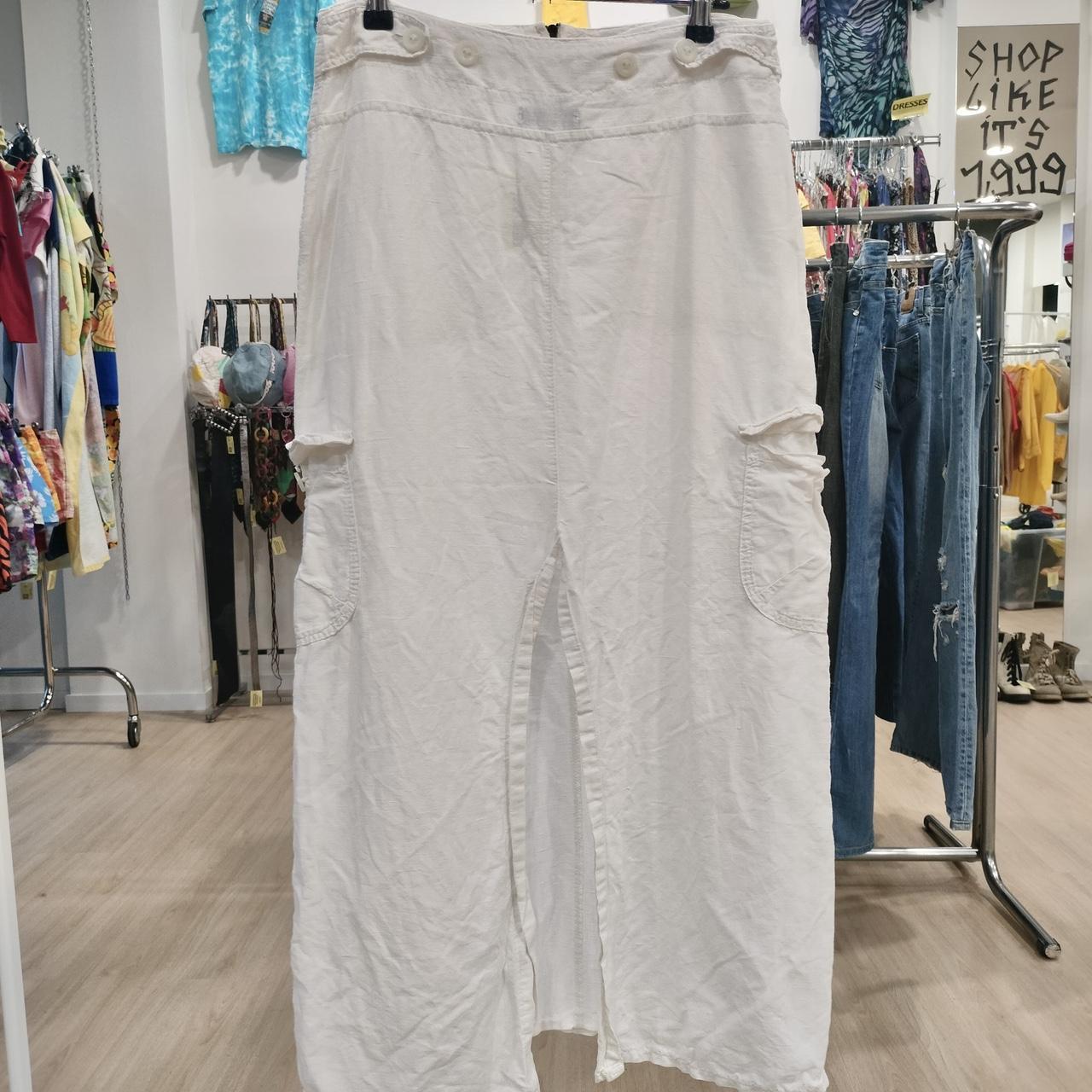 White cargo maxi skirt with front slit and pockets displayed in a second hand fashion store