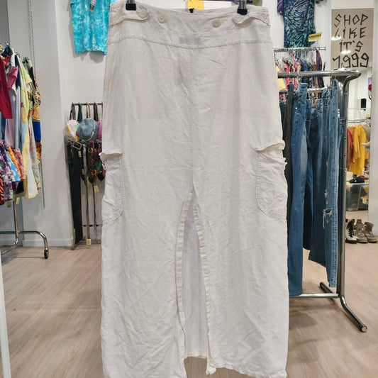 White cargo maxi skirt with front slit and pockets displayed in a second hand fashion store