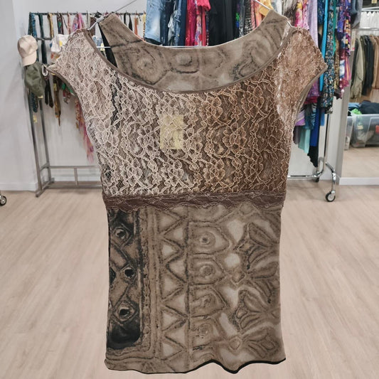 Patterned dress with lace details on a hanger in a store setting