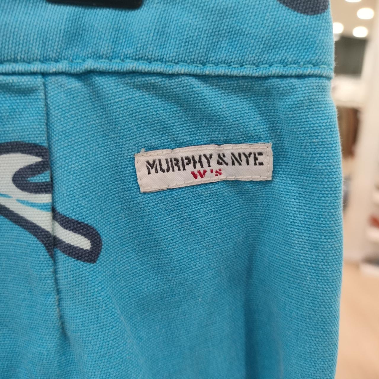 Blue fabric with a 'Murphy & Nye' label on a blurred background