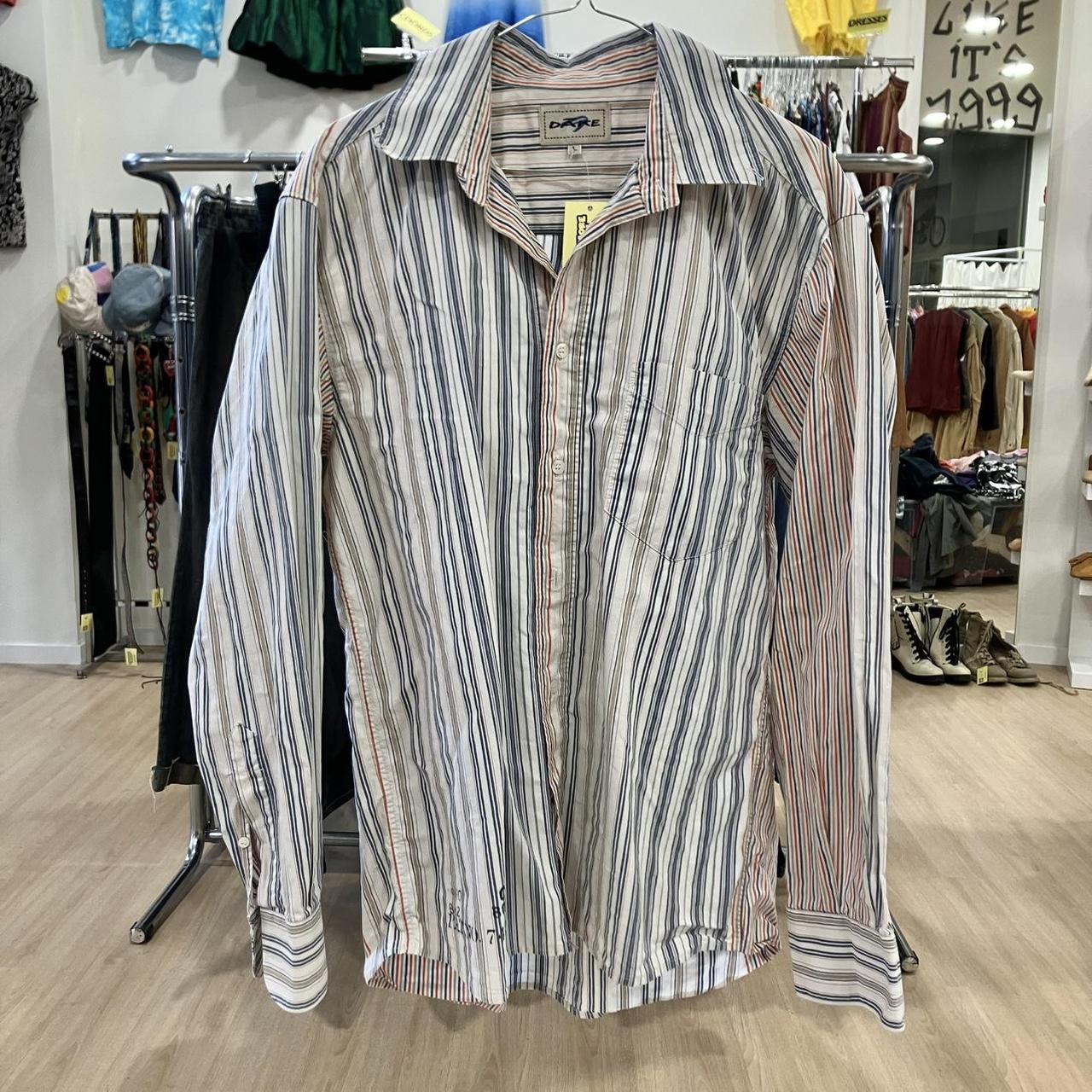 Striped shirt hanging on a rack in a store setting