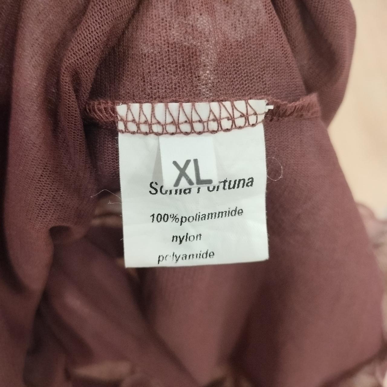 Brown sheer fabric garment label showing XL size, 100% polyamide, nylon material