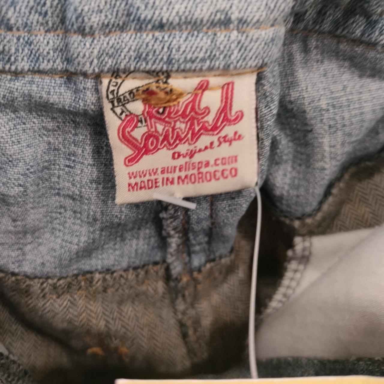 Close-up of a label on denim fabric with 'Red Soul' branding