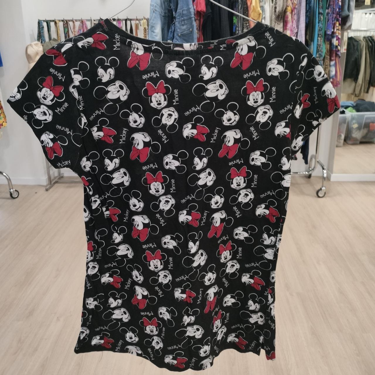 Black t-shirt with Mickey and Minnie Mouse cartoon print, displayed in a secondhand clothing store