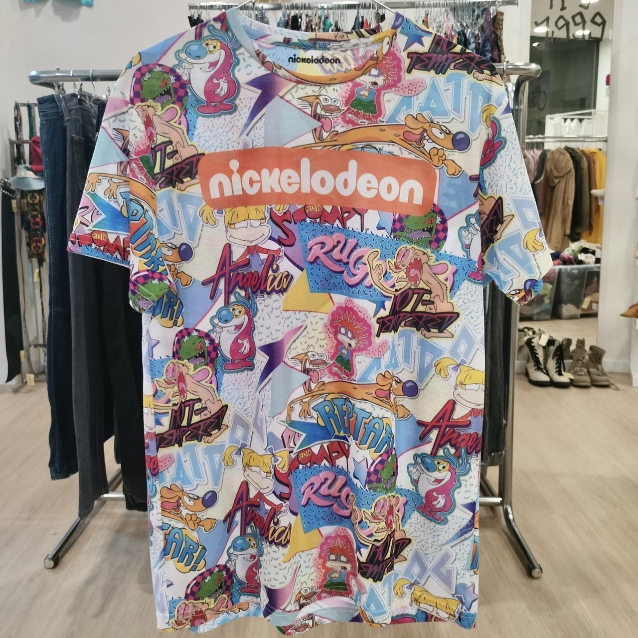 Colorful t-shirt with Nickelodeon character logos on a rack in a store