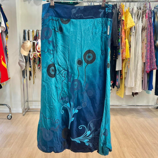 Blue skirt with floral patterns hanging on a rack in a store