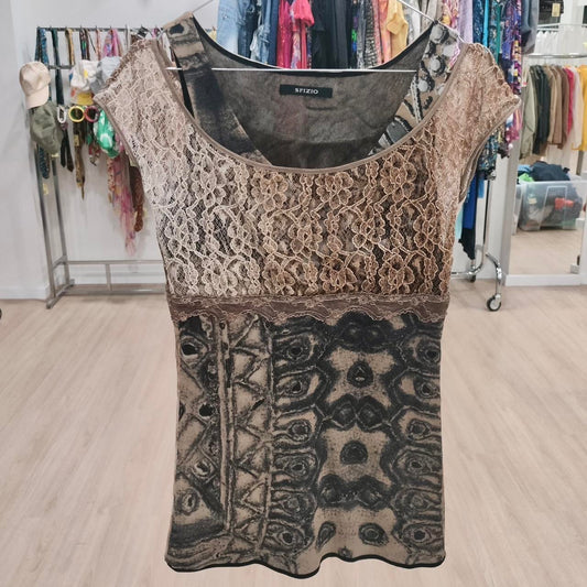 Patterned top with lace details on a wooden floor in a store setting