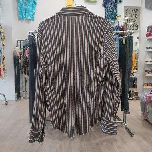 Striped shirt on a rack in a store setting with various items in the background