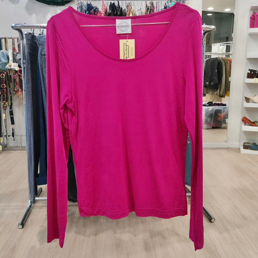 Pink long-sleeve shirt on a rack in a store setting