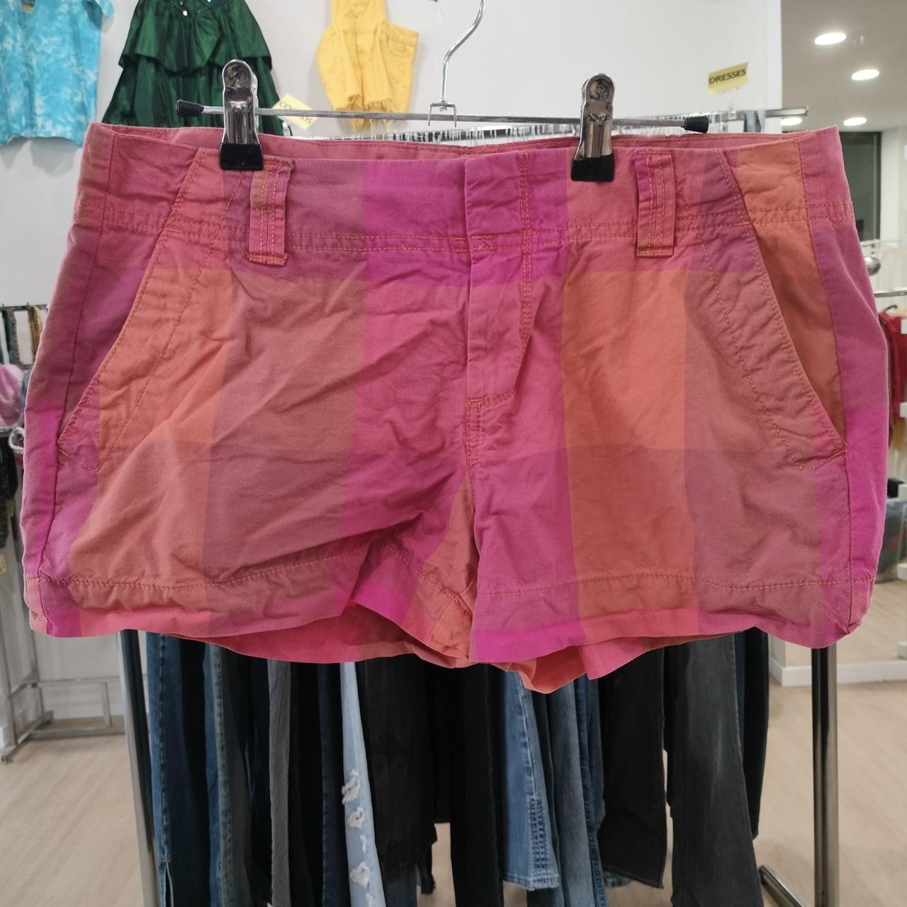 Pink shorts on a rack with a blurred store background