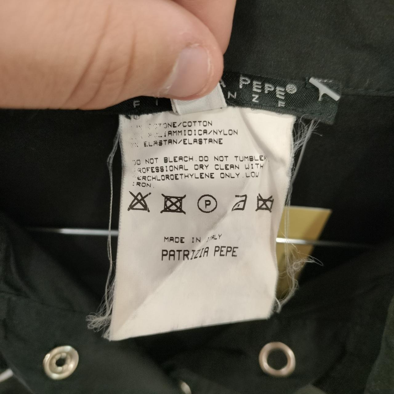 Clothing label with care instructions and brand name on a garment