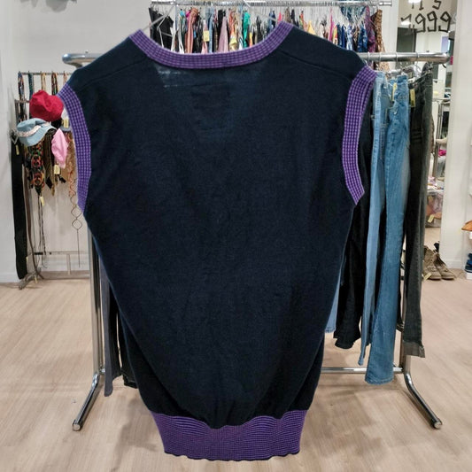 Black sleeveless sweater with purple trim displayed in a second hand clothing store