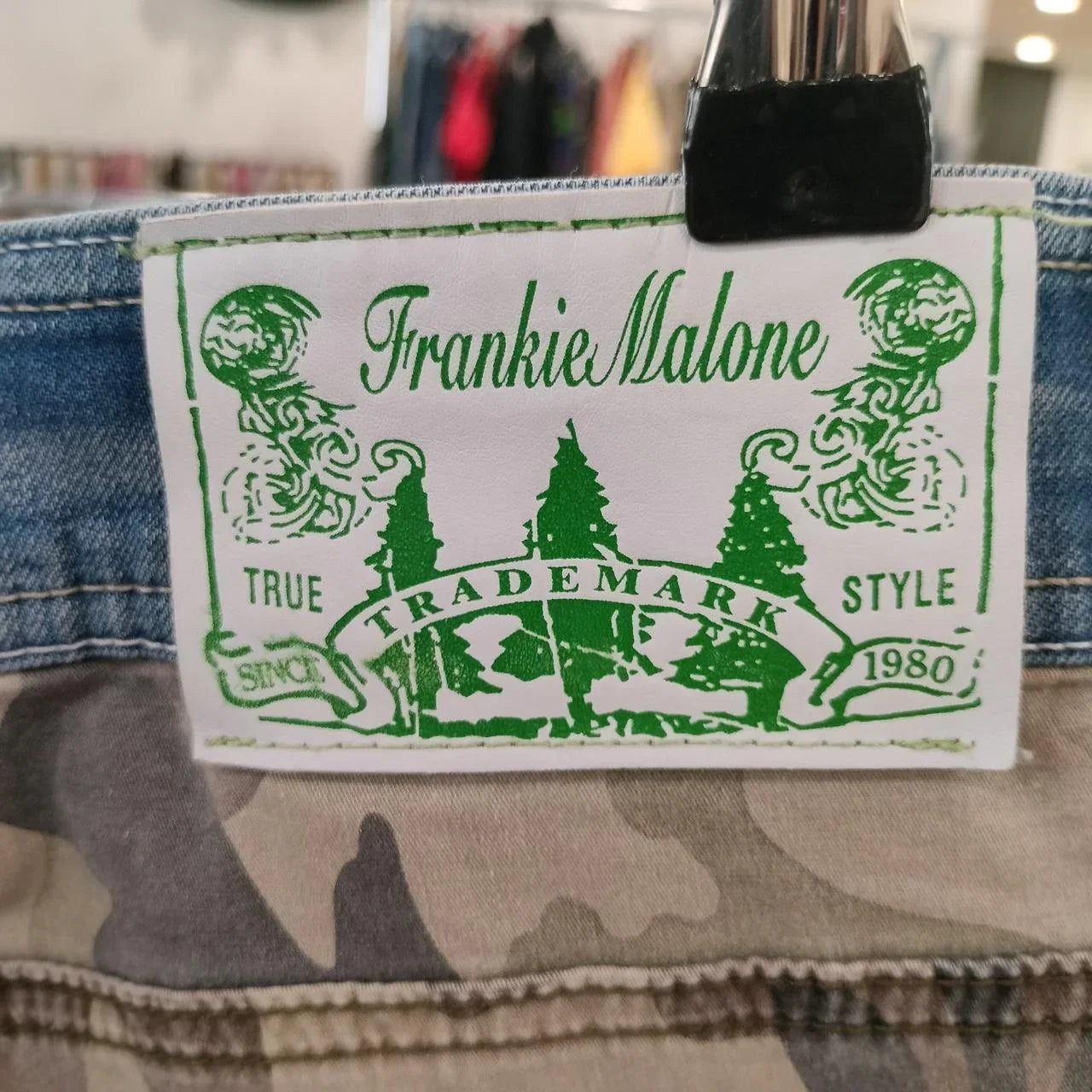Frankie Malone green label on camouflage and denim pants, sustainable second hand fashion