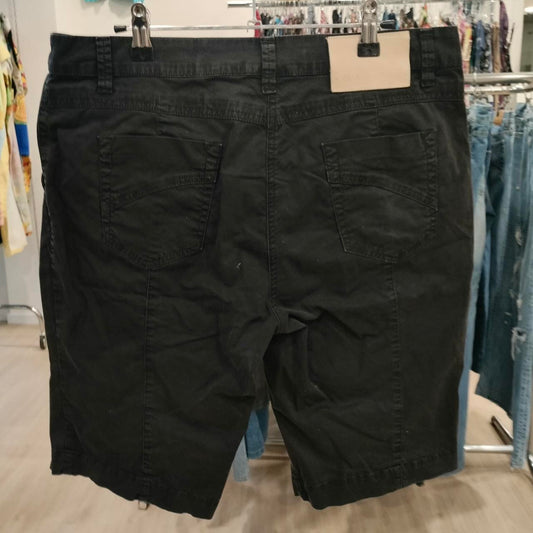 Black denim shorts with back pockets displayed in a second hand clothing store