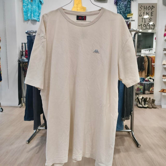 Beige t-shirt with a small logo on a hanger in a store setting
