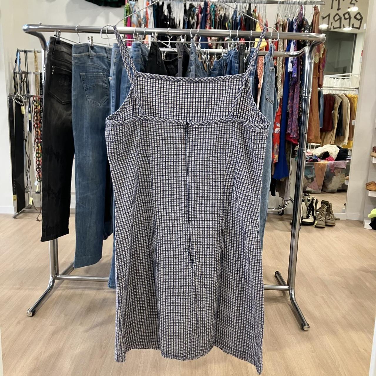 Plaid dress hanging on a rack in a store setting