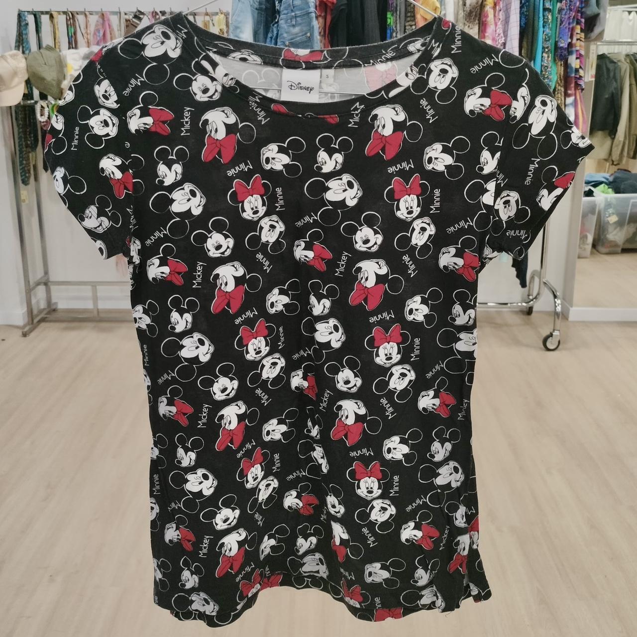 Black Disney t-shirt with Mickey and Minnie Mouse faces, red bows, displayed in thrift store
