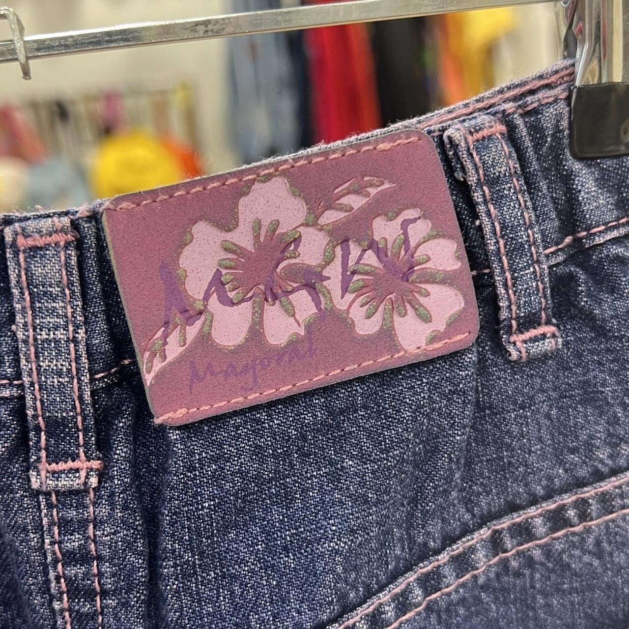 Close-up of a denim product with a floral label in a store setting