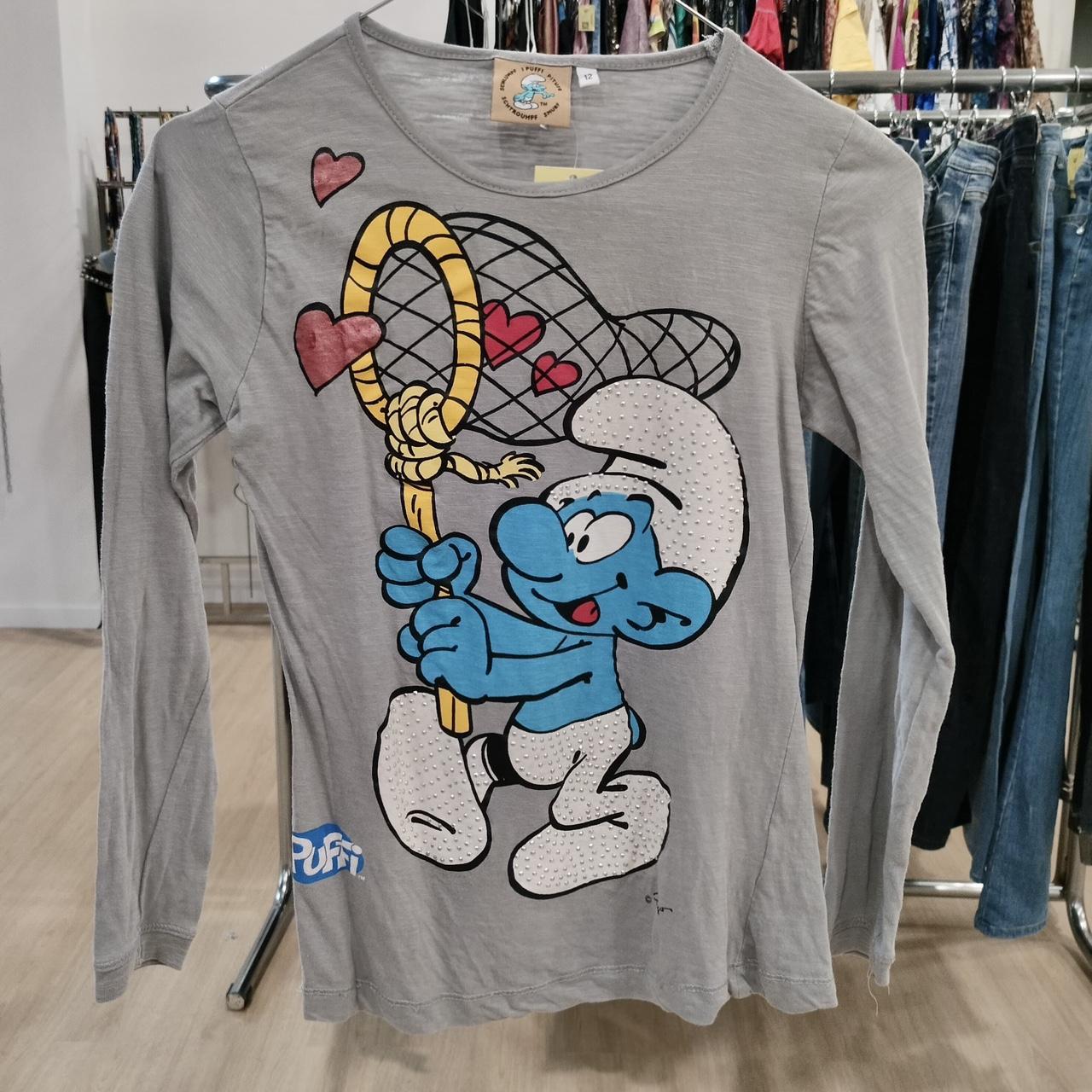 Gray long sleeve shirt with cartoon blue character holding a net surrounded by hearts