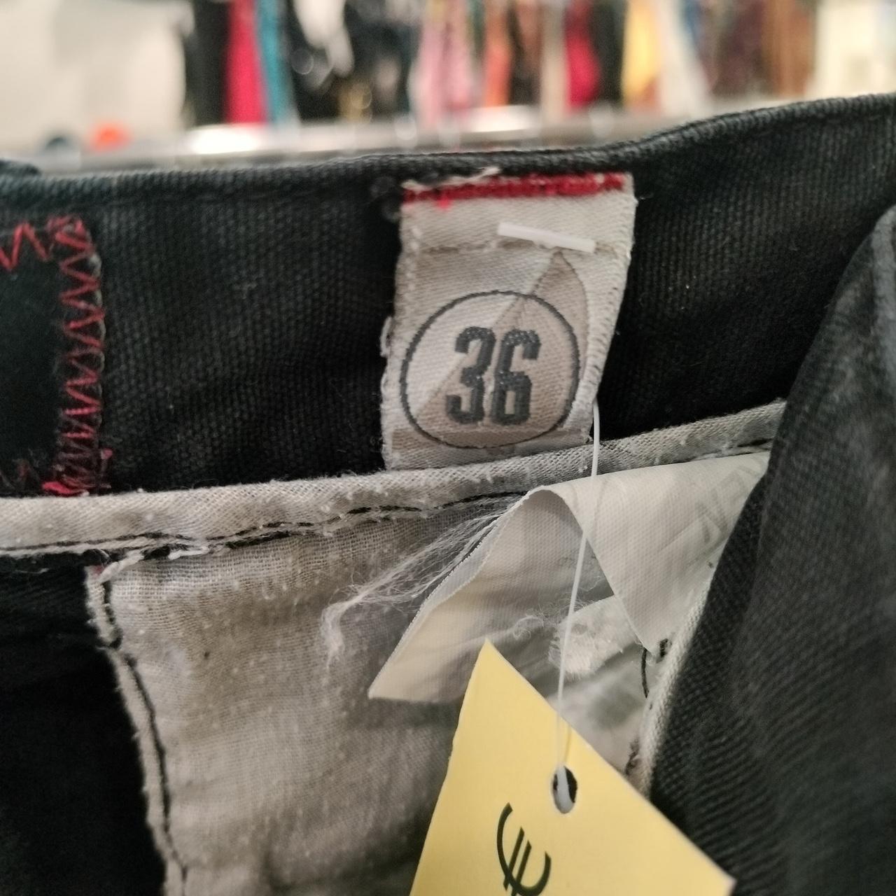 Close-up of clothing waist label showing size 36 on second hand pants