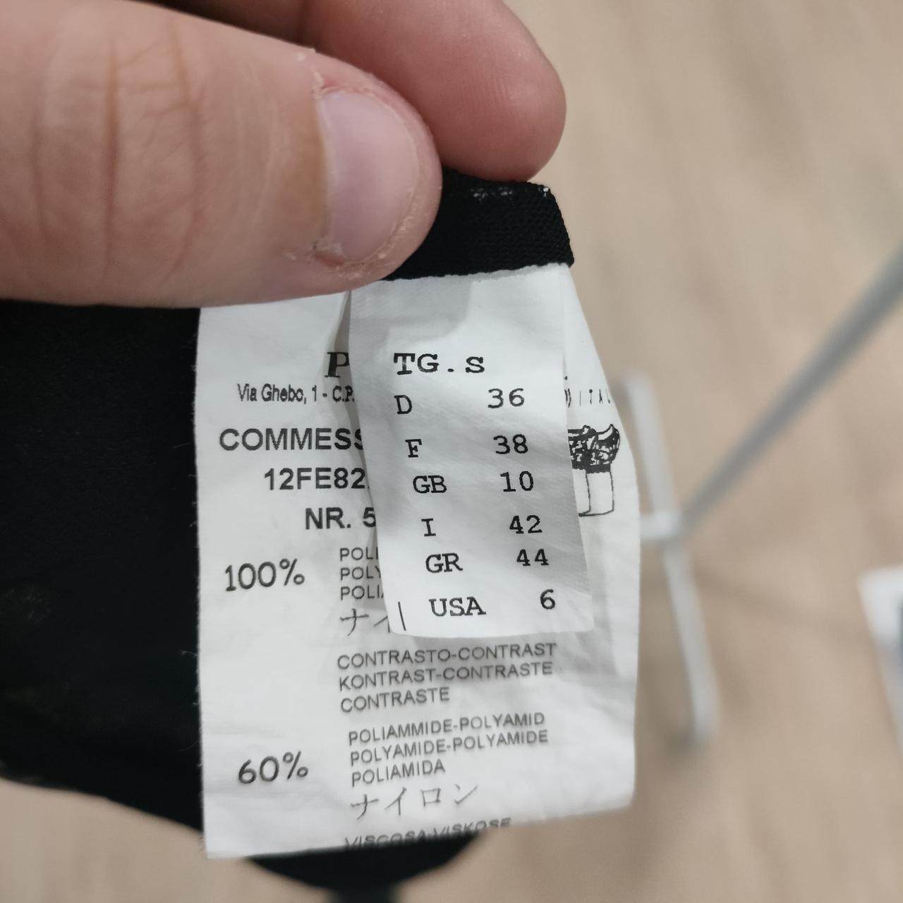 Close-up of a clothing label with text and numbers