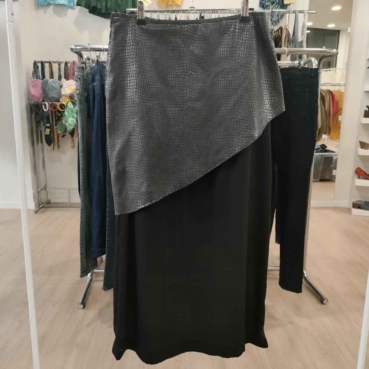 Black and gray skirt hanging on a rack in a store setting