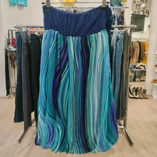 Blue and teal striped flowy skirt hanging in a second hand clothing store