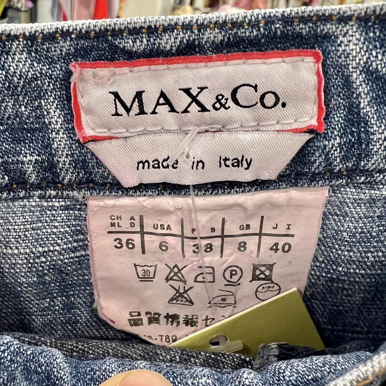 Max & Co. label on denim fabric with size chart and care instructions