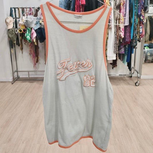 Vintage sleeveless tank top with orange trim and 'Fever 82' embroidery, thrift store setting