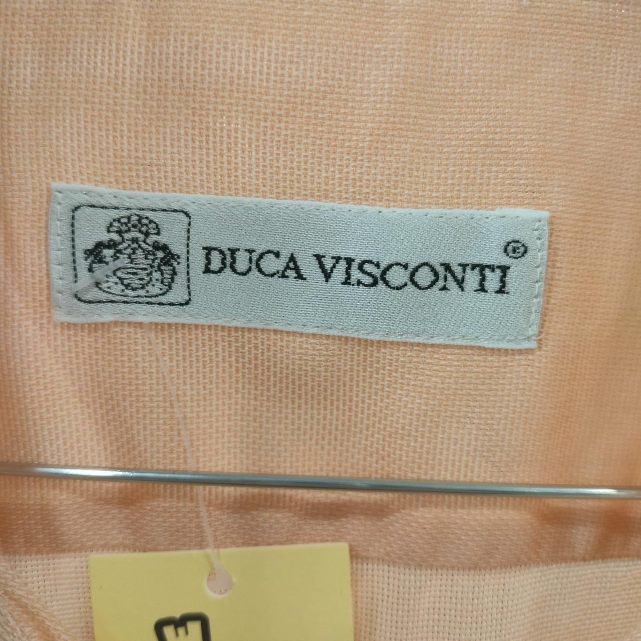 DUCA VISCONTI label on a beige fabric background