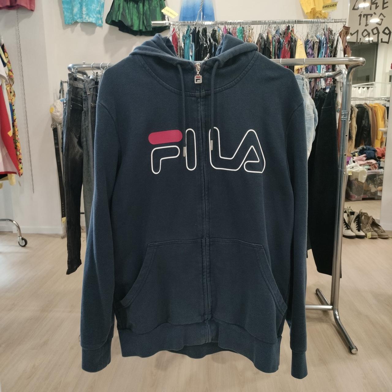 Navy blue hoodie with Fila logo in a store setting